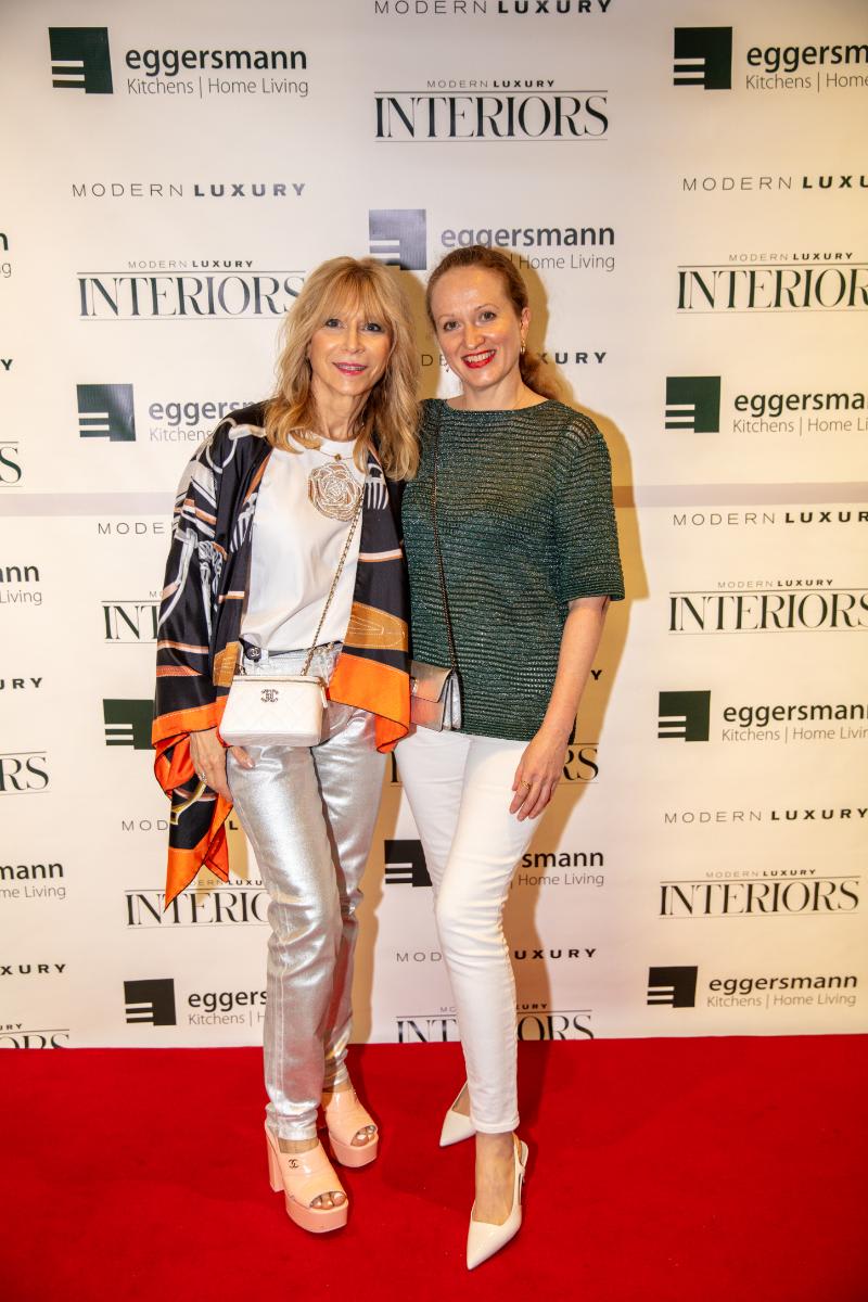 attendees at the chef's night out competition at eggersmann houston's grand re-opening in front of the step-and-repeat display featuring eggersmann modern luxury interiors logos
