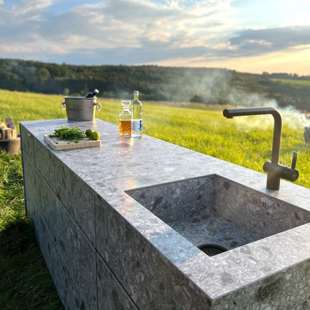 cubic c3 kitchen in a meadow with forest and mountains in the background