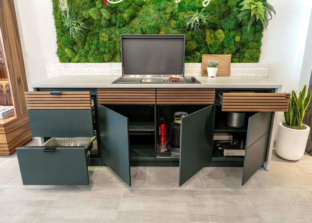all drawers and cabinets open in the c4 kitchen island in the cubic outdoor kitchen display inside eggersmann la showroom
