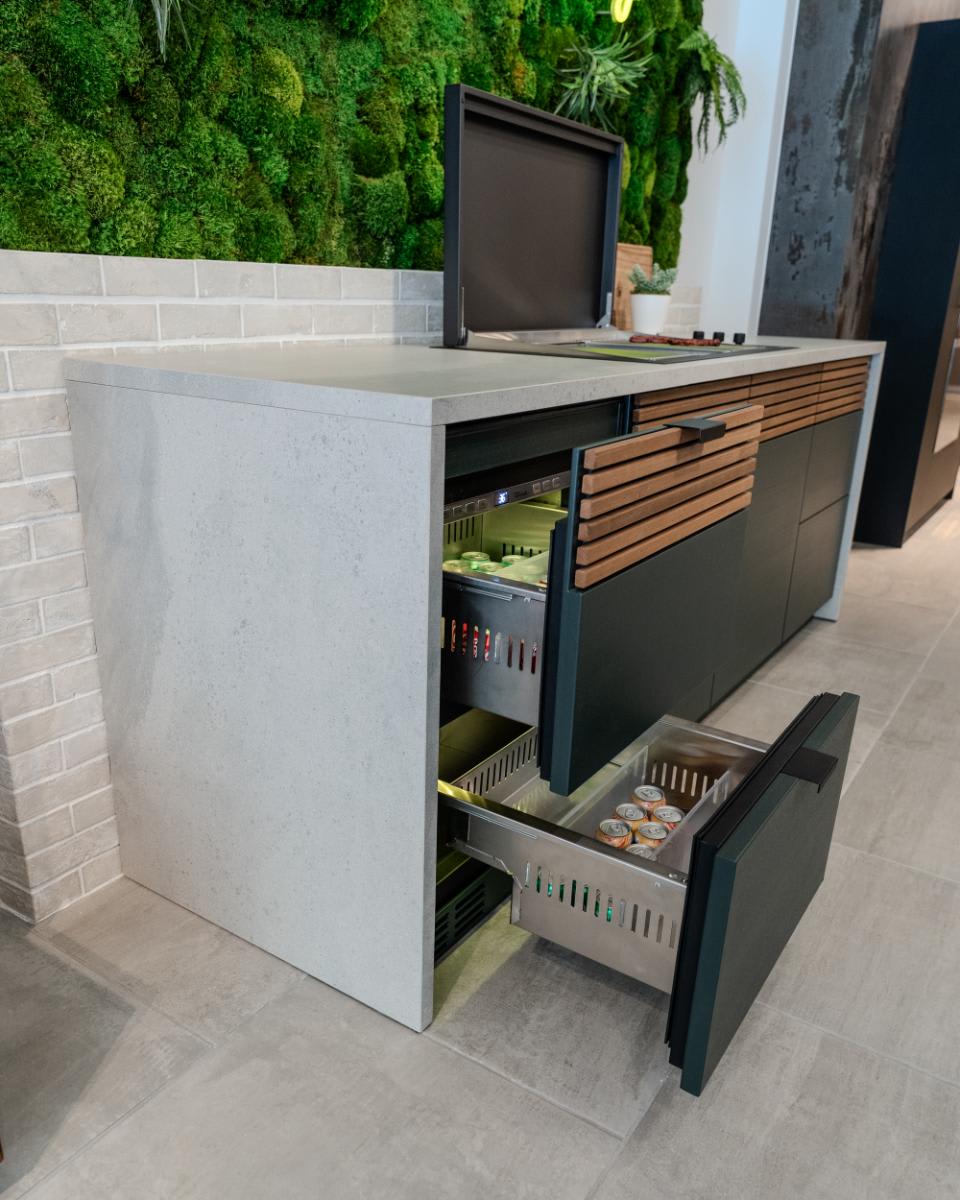 refrigerated drawers open in the c4 kitchen island in the cubic outdoor kitchen display inside eggersmann la showroom