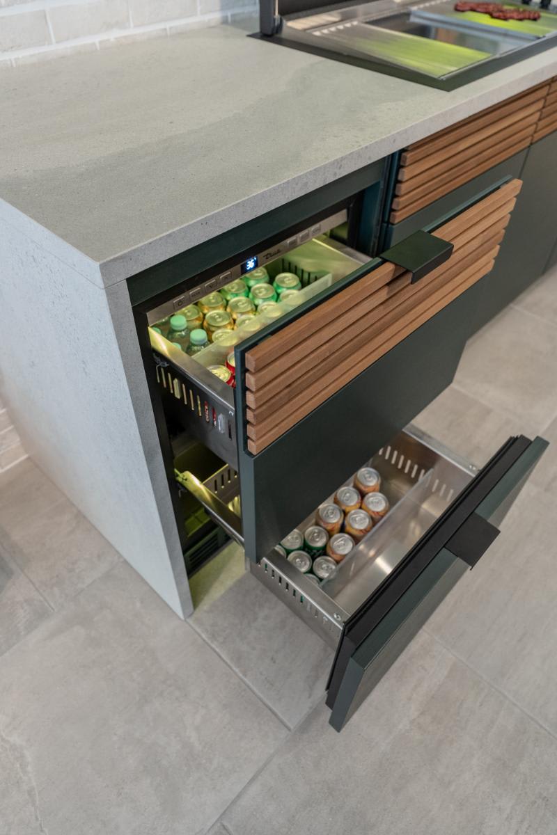 top view of open refrigerated drawers in the c4 kitchen island in the cubic outdoor kitchen display inside eggersmann la showroom
