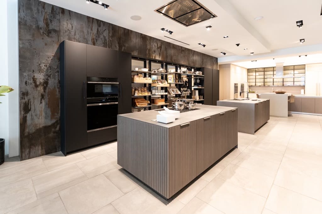 left side view of all turnstile pantries open ithe work's pantry display with dual kitchen islands in the eggersmann la showroom