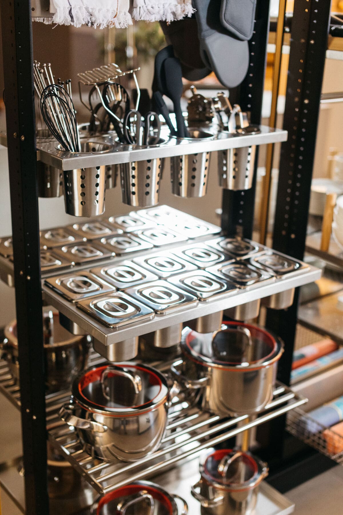 utensil and cookware organizers inside a work's turnstile pantry in the double-island work's kitchen display in the eggersmann la showroom
