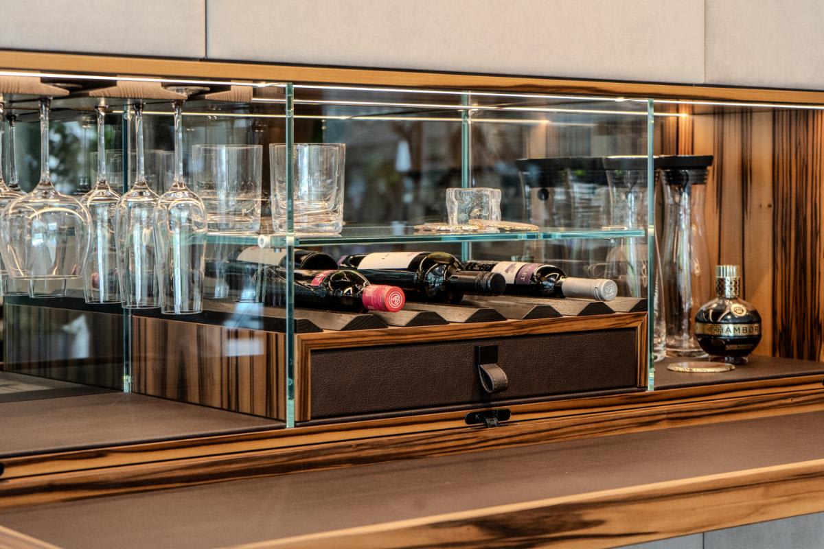 closeup on the opened hidden bar in the living area media wall display in the eggersmann la showroom