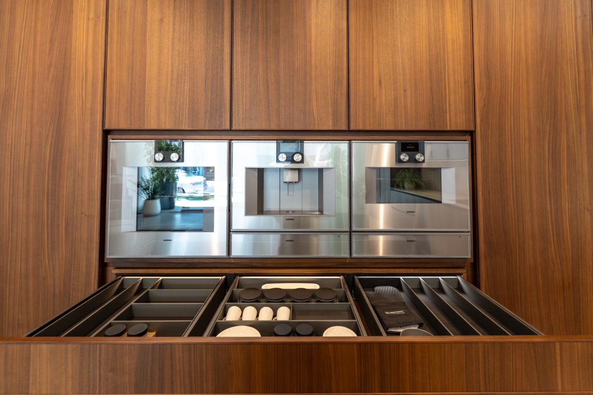 ebx boxtec drawer organizers in a bank of tall wood veneer cabinets with gagganeau appliances