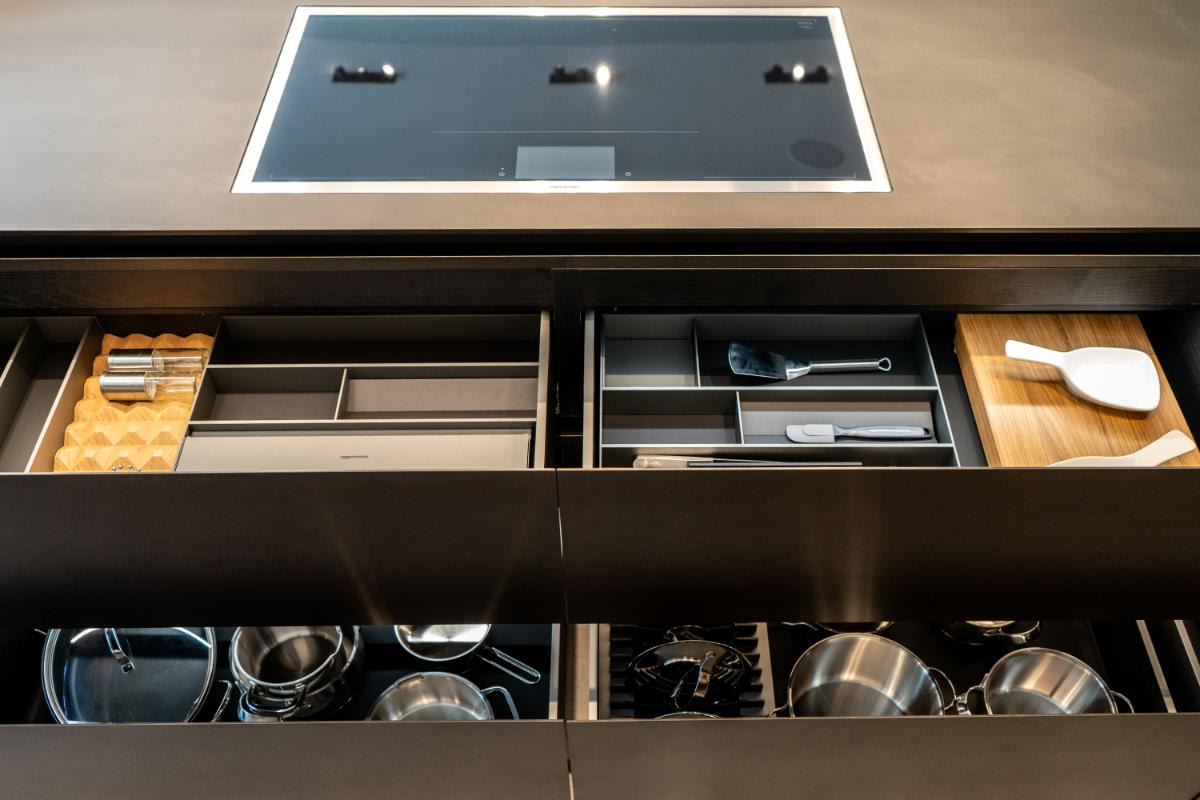 closeup of all custom boxtec organizers in open drawers of the skywalk kitchen island in the eggersmann la showroom