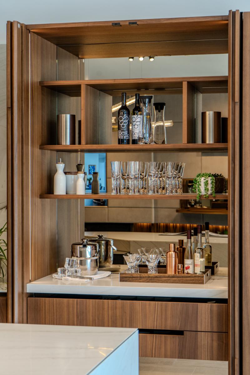 closeup of the beverage station and storage shelving with the double pocket door open in the skywalk kitchen in the eggersmann la showroom