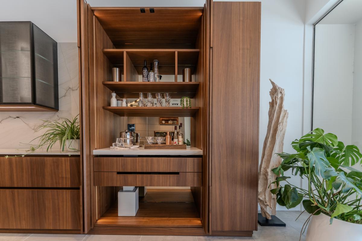 closeup of the double pocket door beverage station and storage shelving in the skywalk kitchen in the eggersmann la showroom