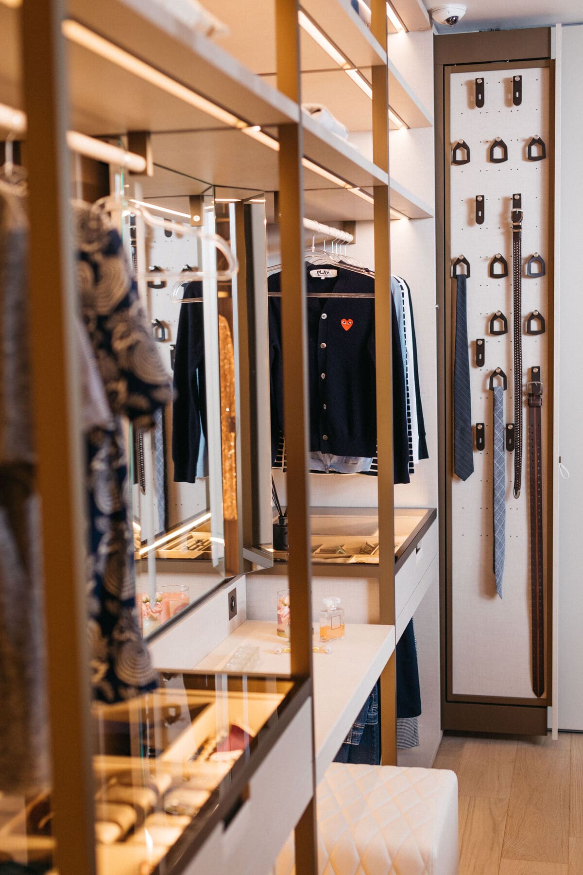 hanging and glass-top accessory storage and pull-out storage for belts and ties in the walk-in wardrobe display in the eggersmann la showroom