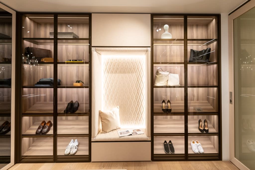 glass-front display storage and tufted upholstered seating niche of the walk-in wardrobe display in the eggersmann la showroom