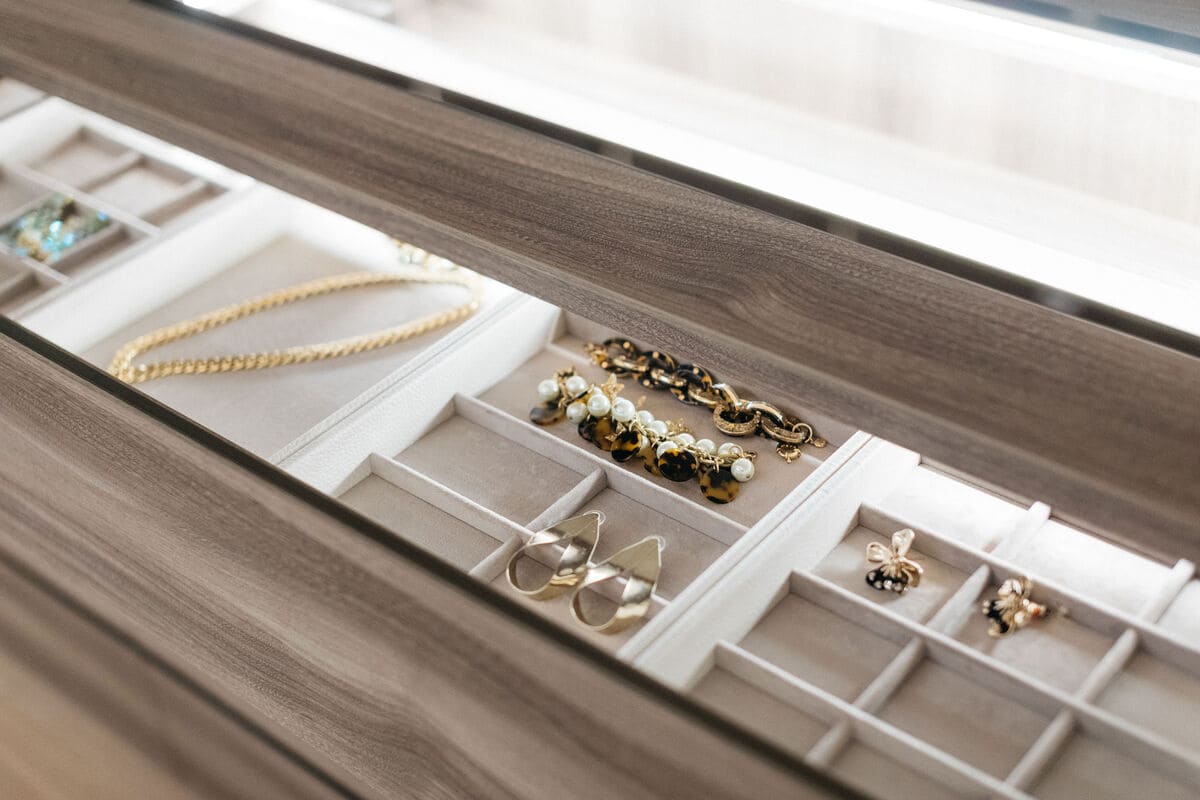 closeup of handcrafted jewelry display organizers in the island of the walk-in wardrobe display in the eggersmann la showroom