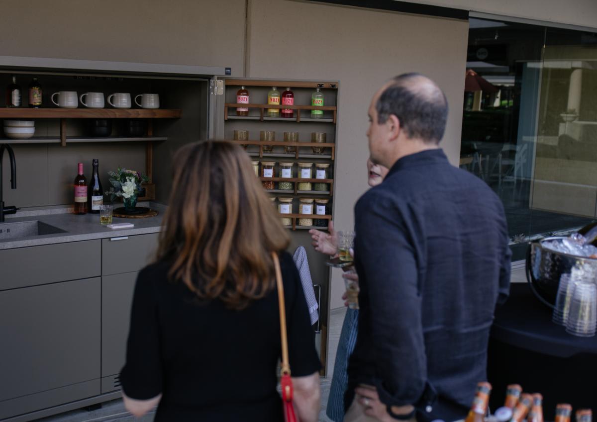 guests inspecting the kitchen in a cupboard in the outdoor kitchen display of eggersmann laguna during the CUBIC event in august 2025