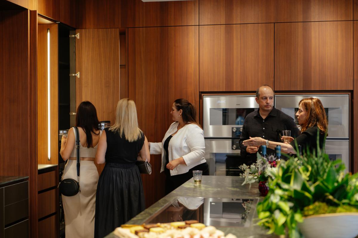 guests exploring the many cabinetry options of an indoor kitchen display of eggersmann laguna during the CUBIC event in august 2025