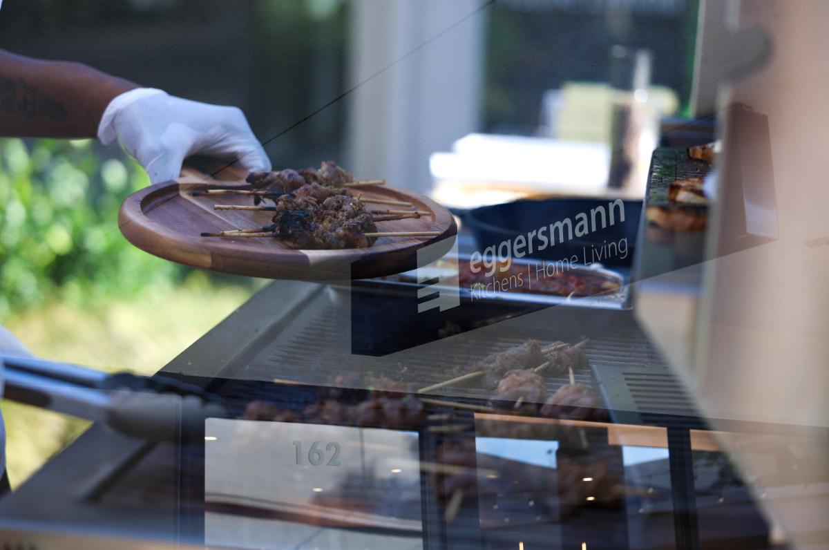 grilled brisket skewers coming off the grill in the outdoor kitchen of eggersmann laguna during the CUBIC event in august 2025