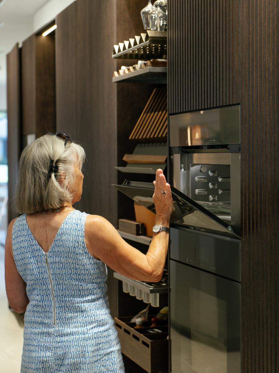 a guest explores the luxury appliances in an indoor kitchen display during the CUBIC event in august 2025 at eggersmann laguna