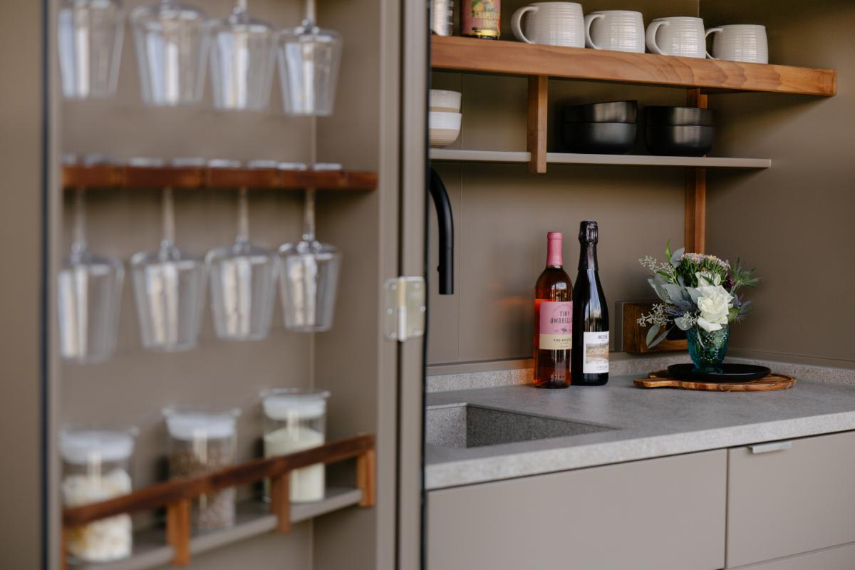 close-up of the glassware and other storage options in the kitchen in a cupboard in the outdoor kitchen display at eggersmann laguna during the CUBIC event in august 2025