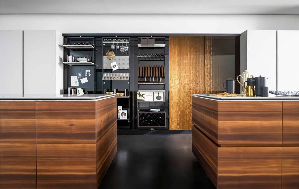 work's turnstile pantries with fronts in interlink bronze in a dual island kitchen work's turnstile pantries with fronts in interlink bronze in a dual island kitchen
