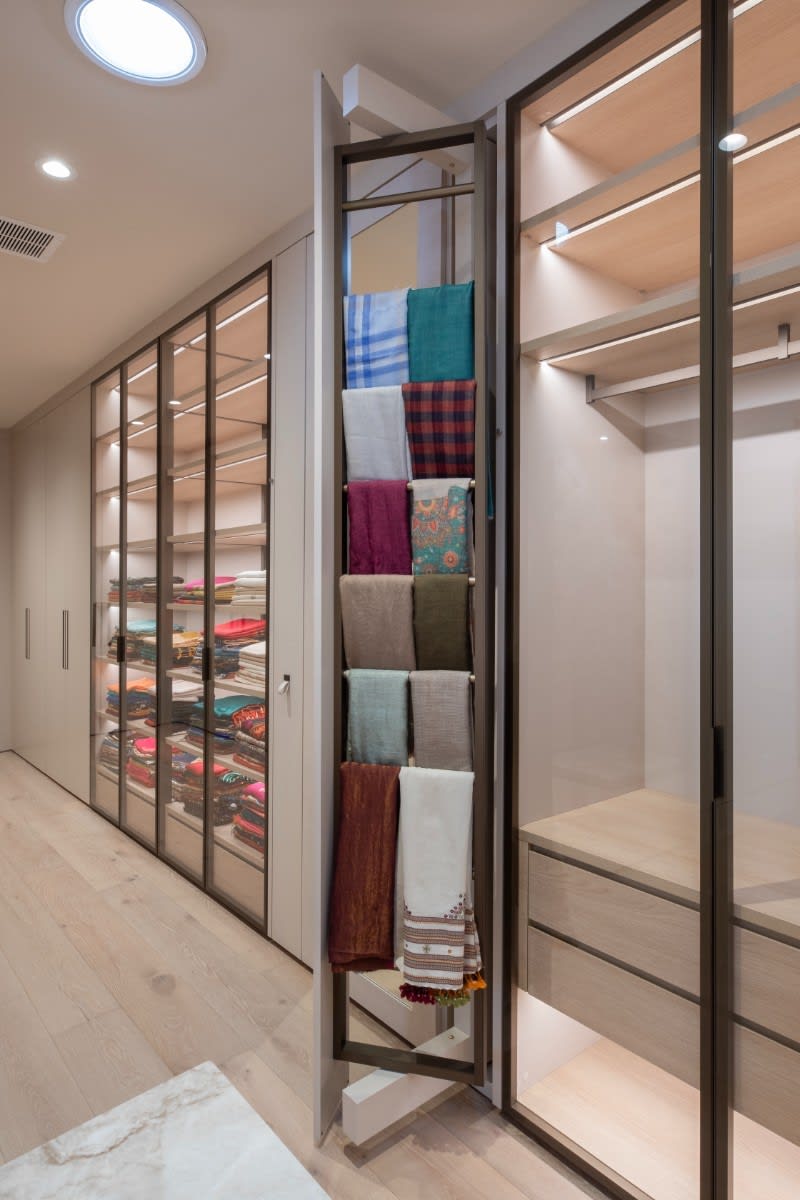 pull-out scarf rack in a wardrobe designed by eggersmann scottsdale in a fulton ranch home