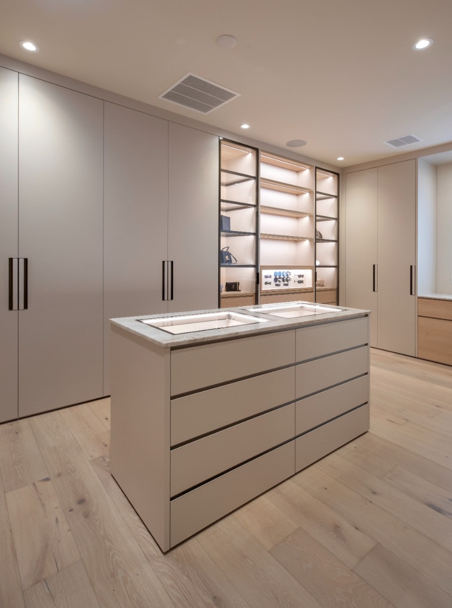 closet island with jewelry display case in a wardrobe designed by eggersmann scottsdale in a fulton ranch home