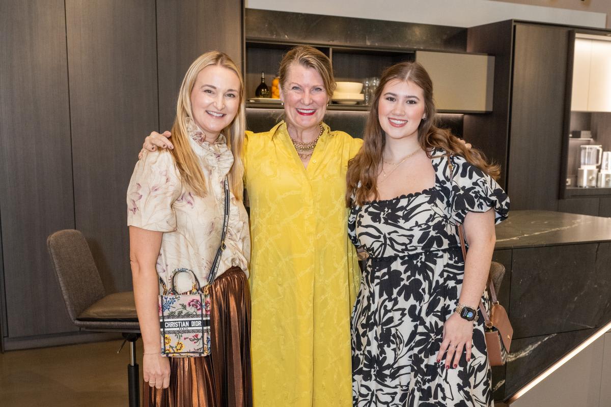 jennifer cope of modern luxury magazine poses with jennifer burgess loh and hannah huston of burgess loh designs at the aia home tour 2025 appreciation party in the eggersmann houston showroom
