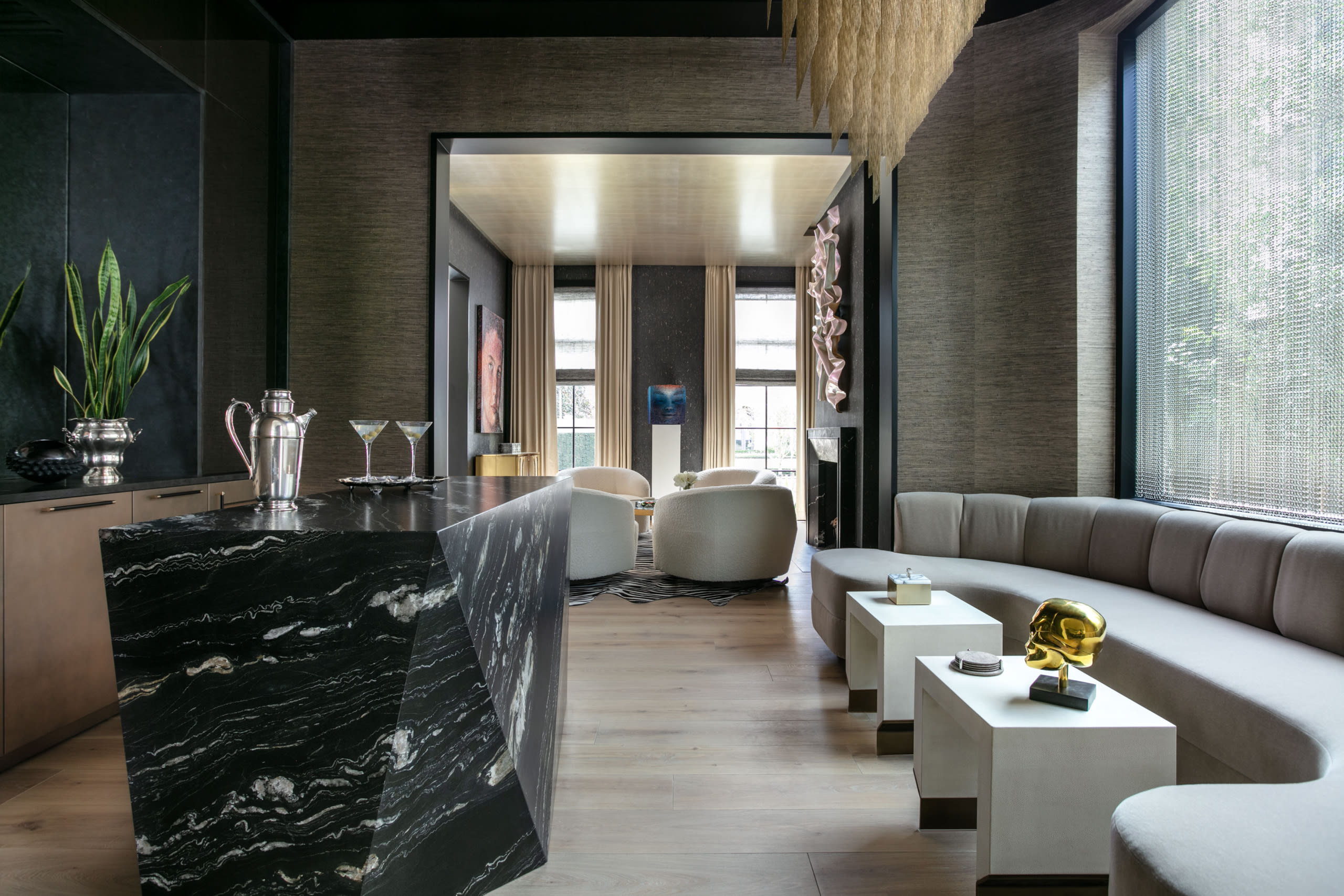 island of custom luxury bar designed by eggersmnn houston next to lounge