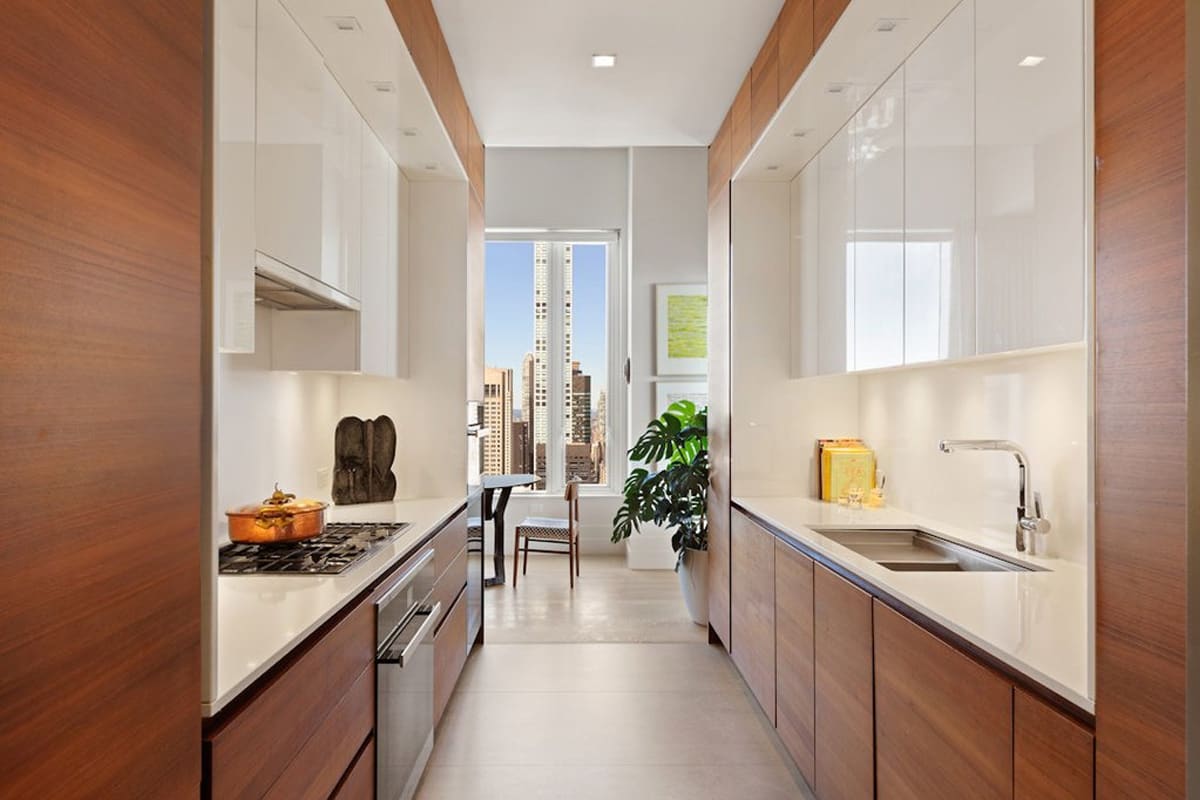 galley of an eggersmann-designed kitchen featuring wood veneer and gloss white finishes in a residence of 252 east 57th st of nyc