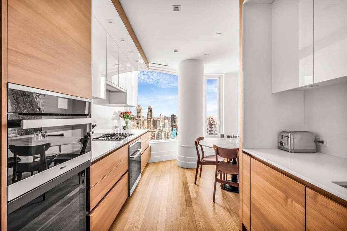 galley of a wood veneer and gloss white kitchen designed by eggersmann residence in 252 east 57th st of nyc