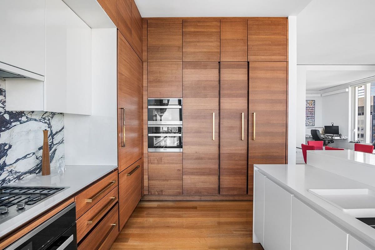 galley and wood-veneered wall cabinetry of a kitchen designed by eggersmann residence in 252 east 57th st of nyc