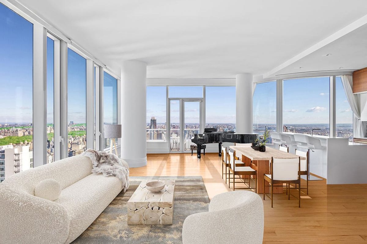 grand city views from living area with grand piano and luxury white gloss and wood veneer kitchen designed by eggersmann residence in 252 east 57th st of nyc