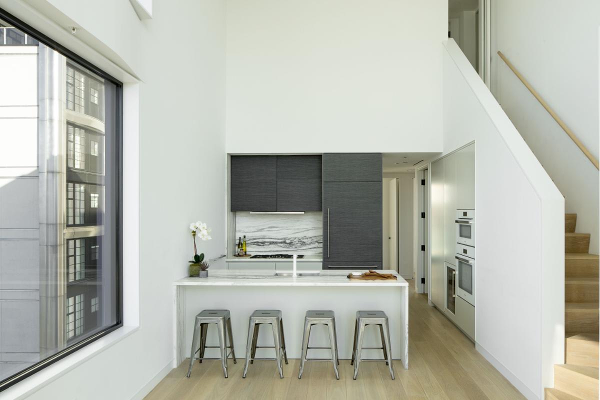 dark wood veneer and white gloss lacquer finishes in a kitchen designed by eggersmann in a residence of chelsea waterside nyc