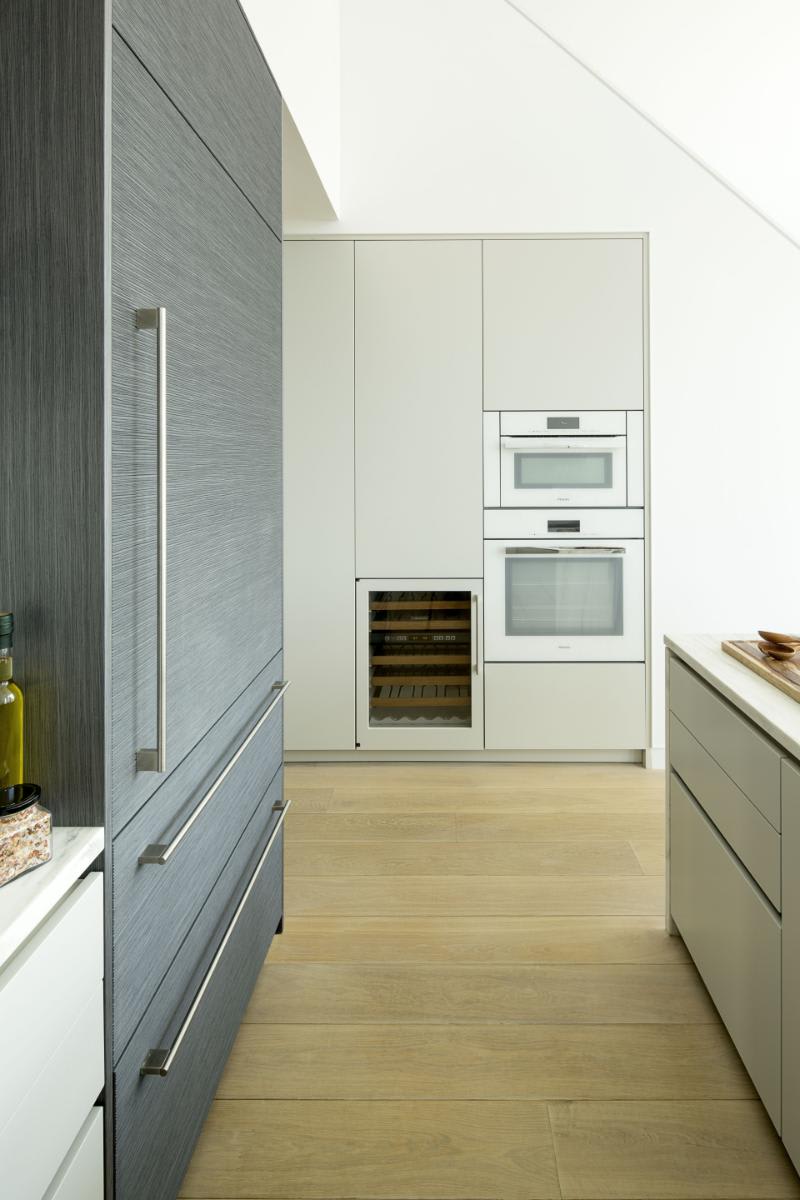 galley of dark wood veneer and white gloss kitchen designed by eggersmann in a residence of chelsea waterside nyc