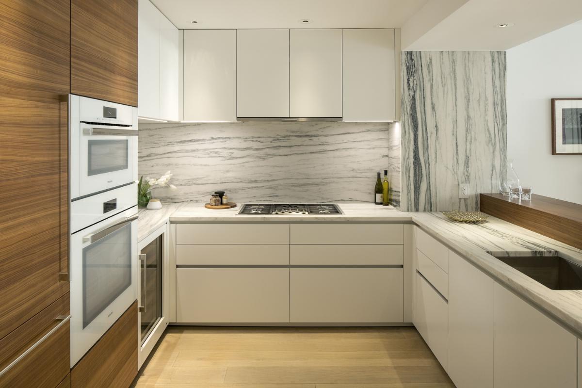 wood veneer and white decor laminate finishes in a kitchen designed by eggersmann in a residence of chelsea waterside nyc
