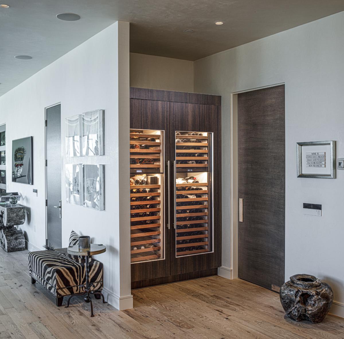 double-door wine fridge tucked away behind a wall in an eggersmann-designed concealed kitchen in a residence of the belfiore high rise in houston tx