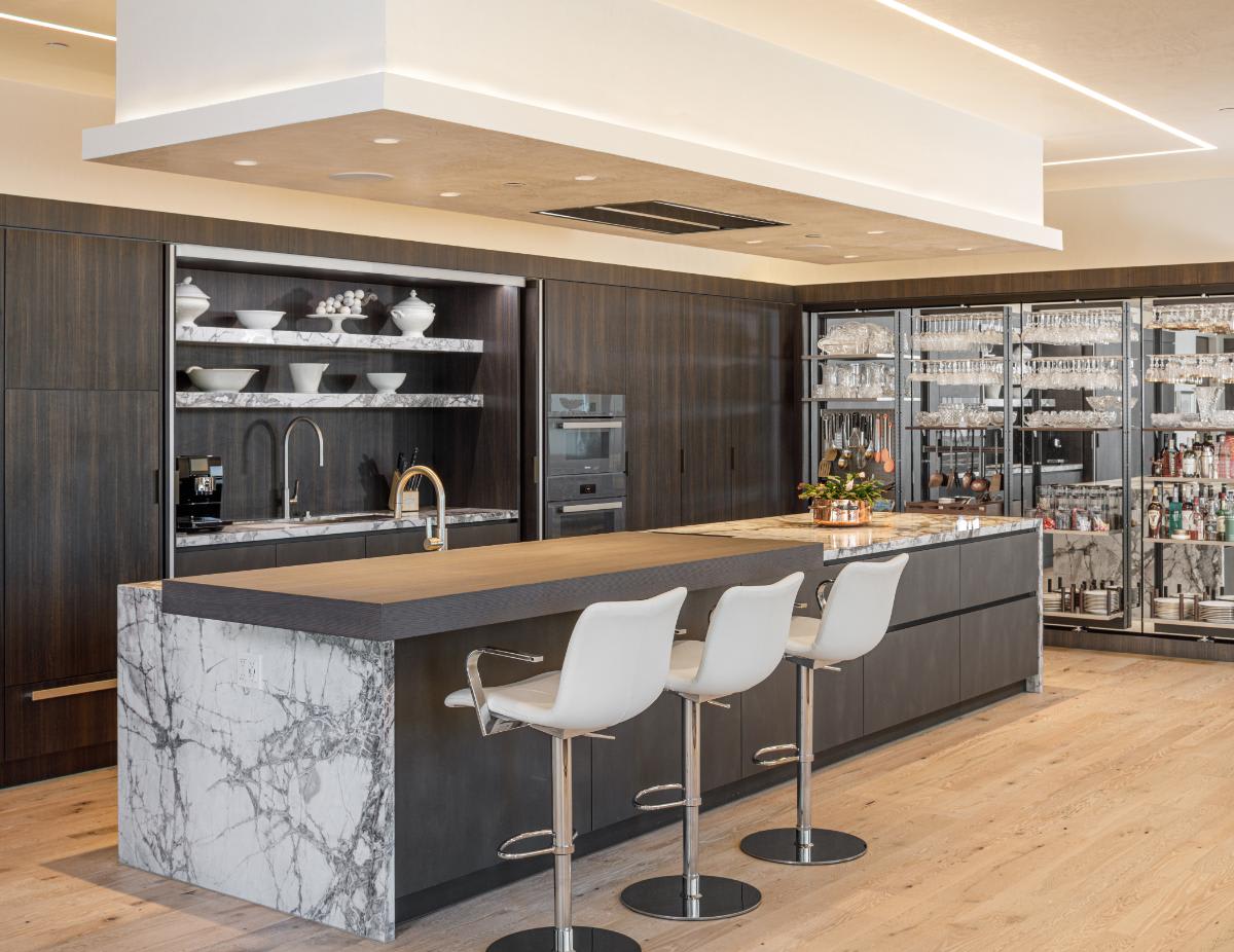 eggersmann-designed concealed kitchen and work's pantries open to reveal custom storage and functionality in a residence of the belfiore high rise in houston tx
