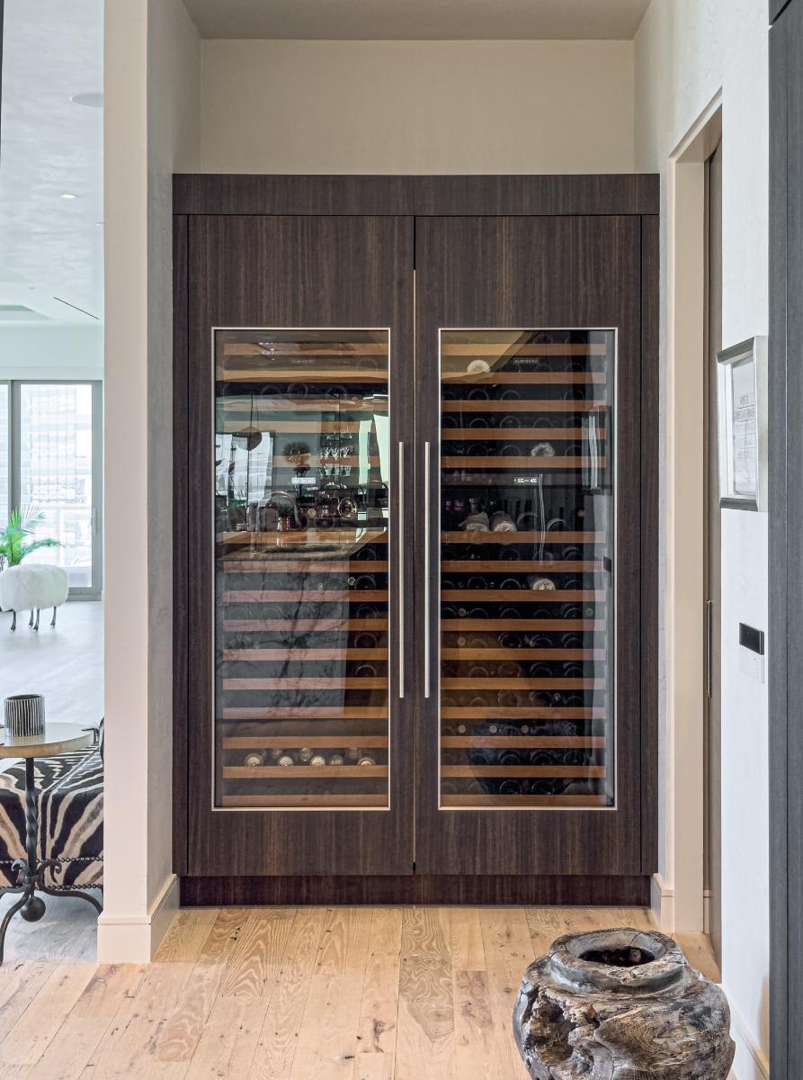 double-door wine fridge in an eggersmann-designed concealed kitchen in a residence of the belfiore high rise in houston tx