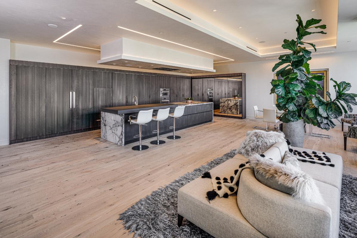 view from the living area of an eggersmann-designed concealed kitchen in a residence of the belfiore high rise in houston tx
