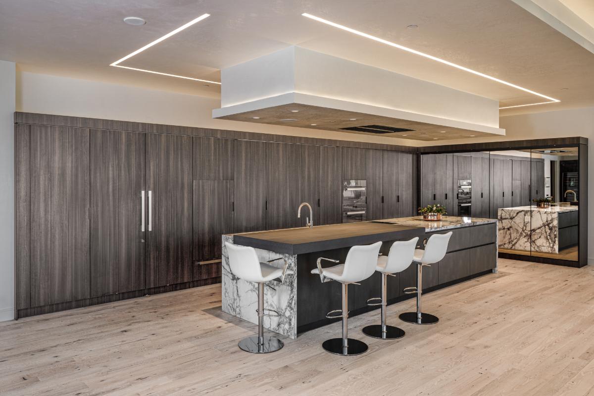 eggersmann-designed wood veneer concealed kitchen in a residence of the belfiore high rise in houston tx