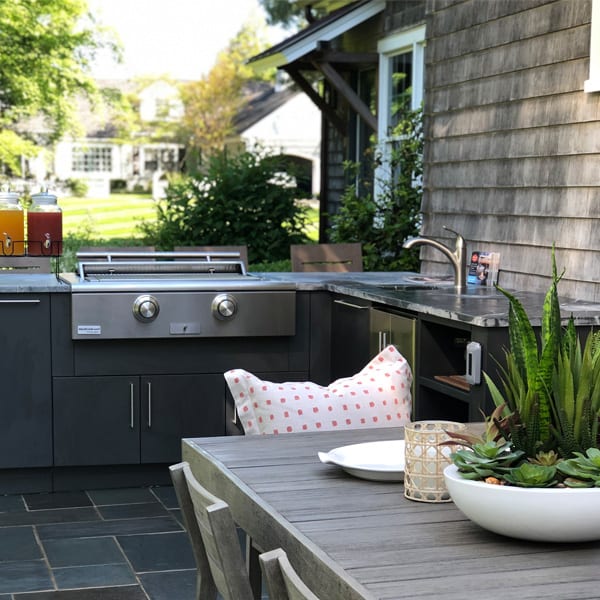 stainless steel luxury grill by true caliber on a patio