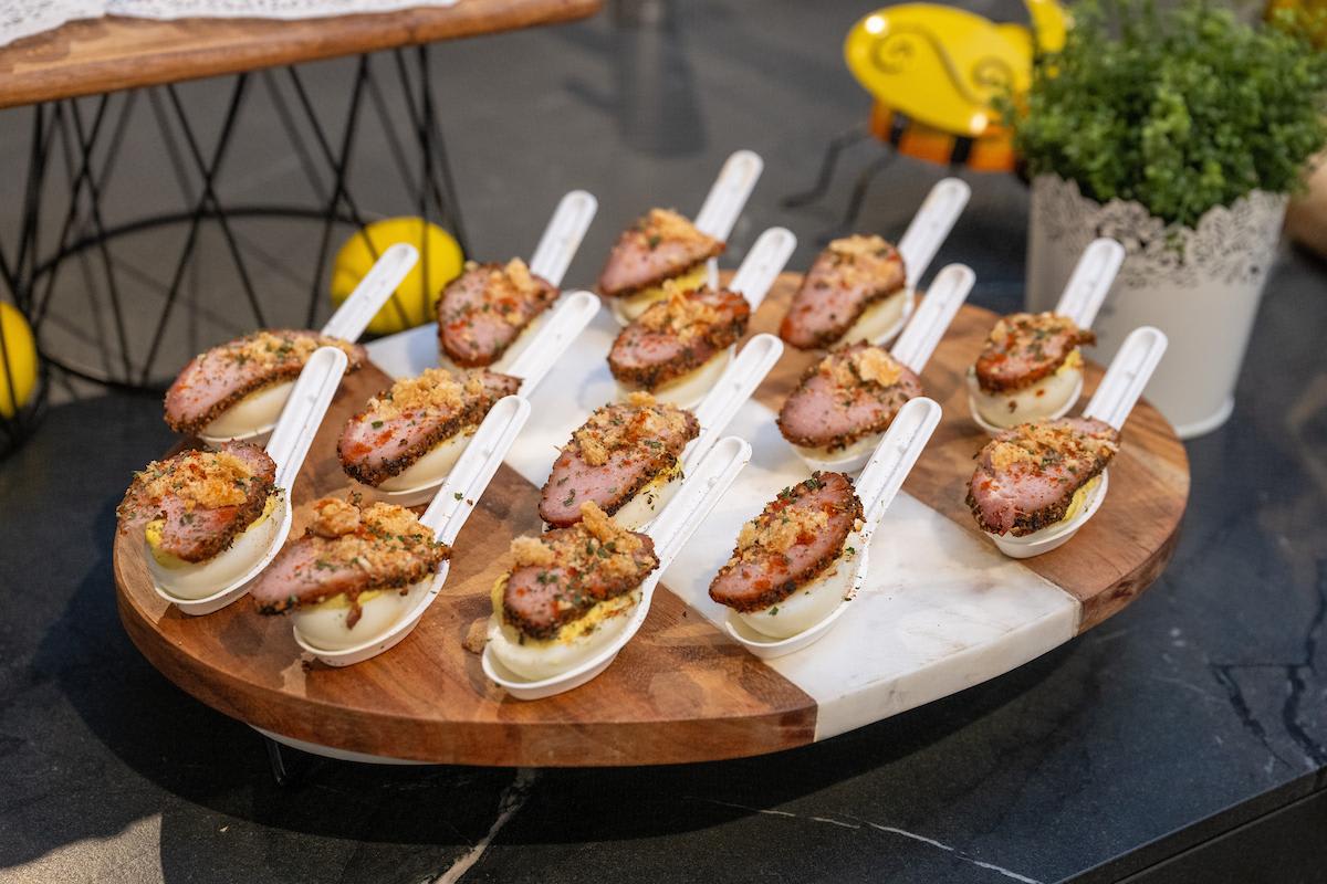 brisket on boiled egg spoons by a mustard seed at the evening of design and culinary excellence event in the eggersmann Houston showroom