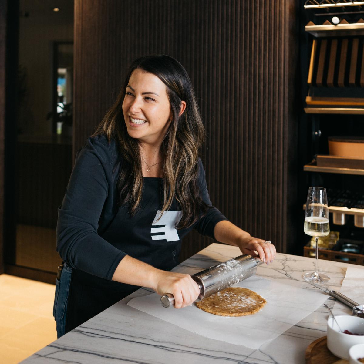 dana mcmanus eggersmann marketing director rolling out dough in an eggersmann showroom kitchen