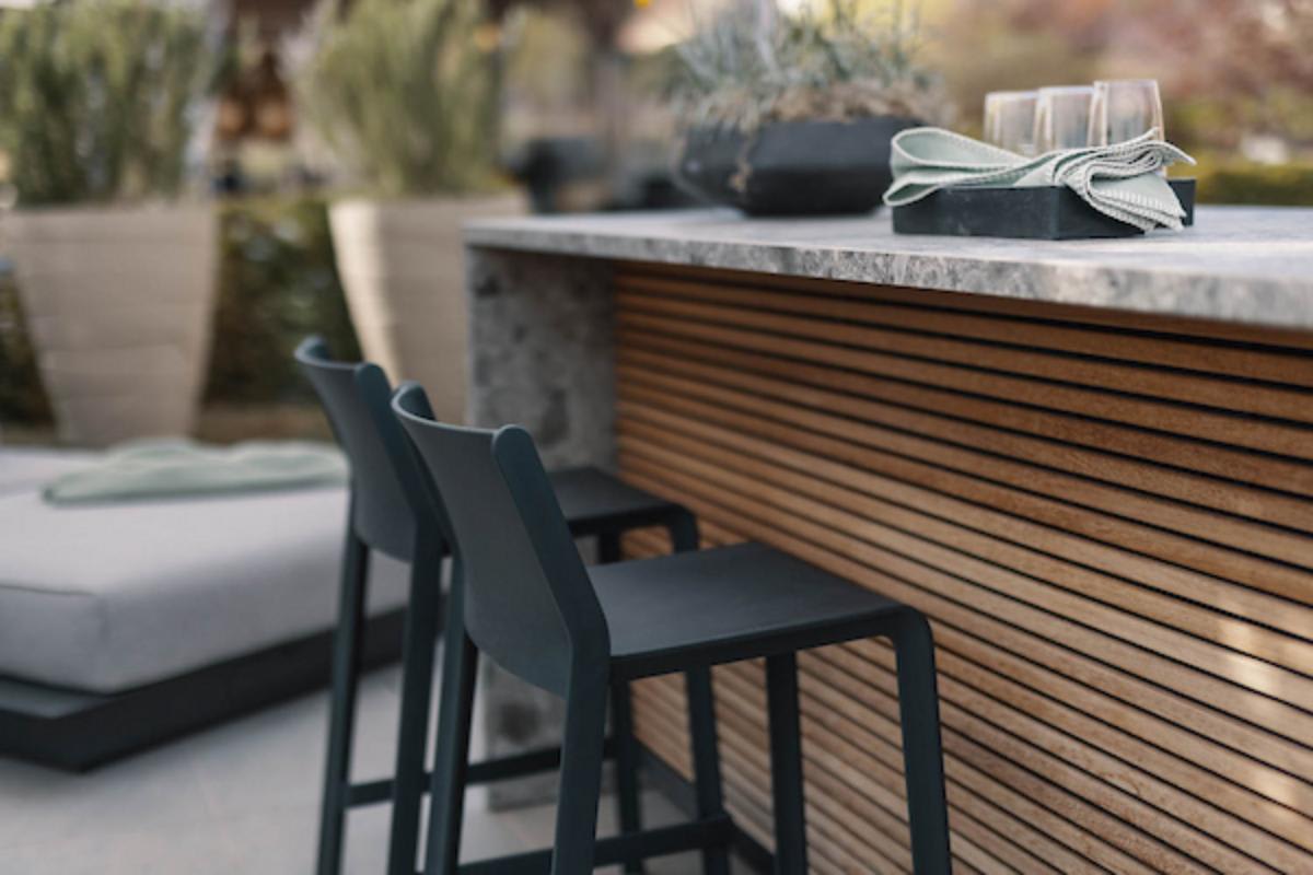 wood-slatted front of a cubic outdoor kitchen island