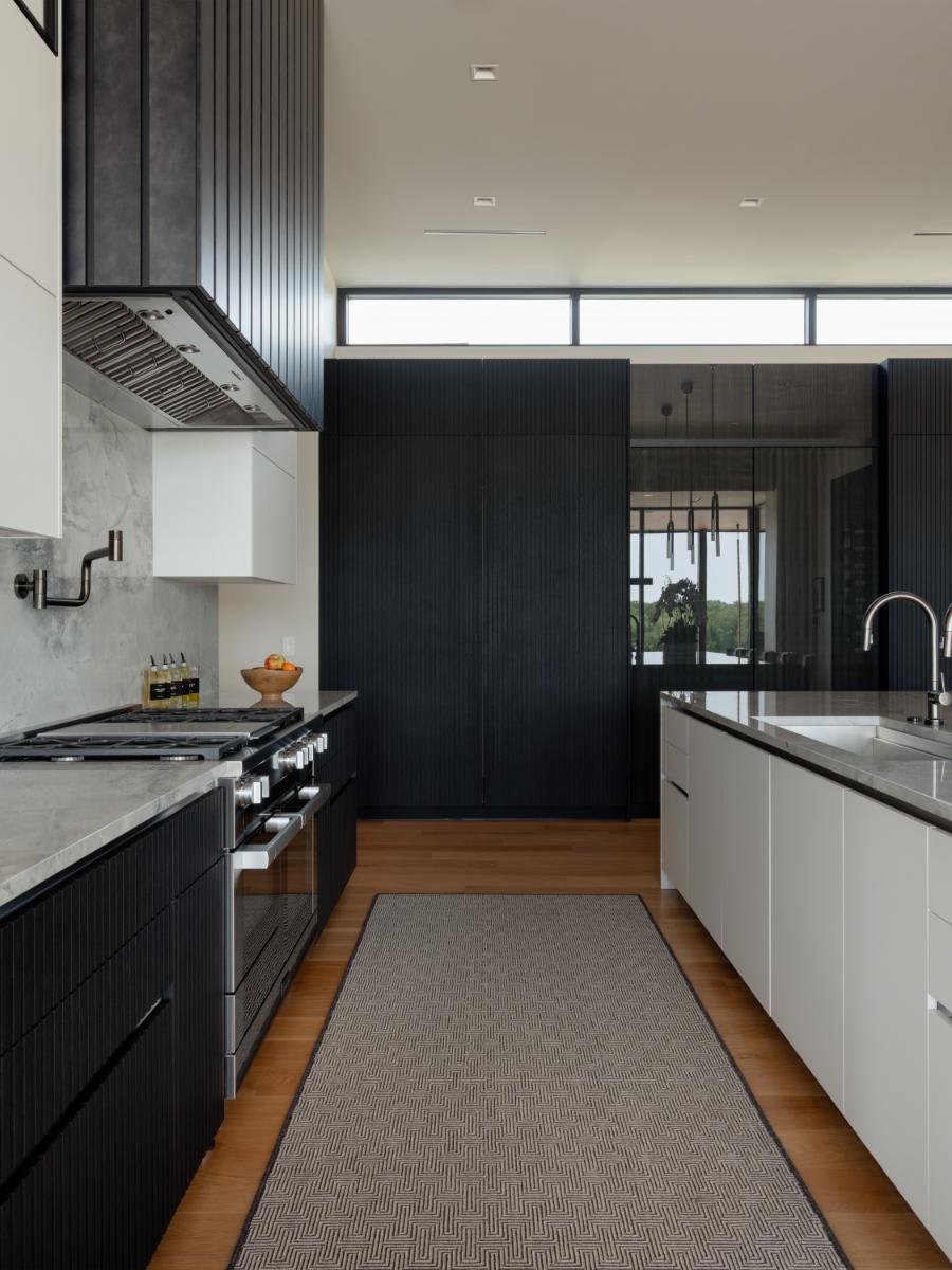 galley of a kitchen with integrated refrigerator door closed designed by eggersmann for a david lewis home