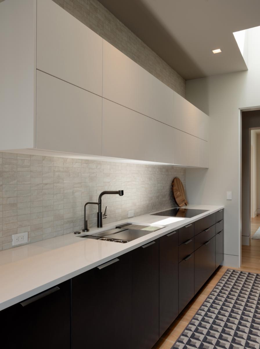 counter and 2-toned cabinetry in a catering kitchen designed by eggersmann for a david lewis home
