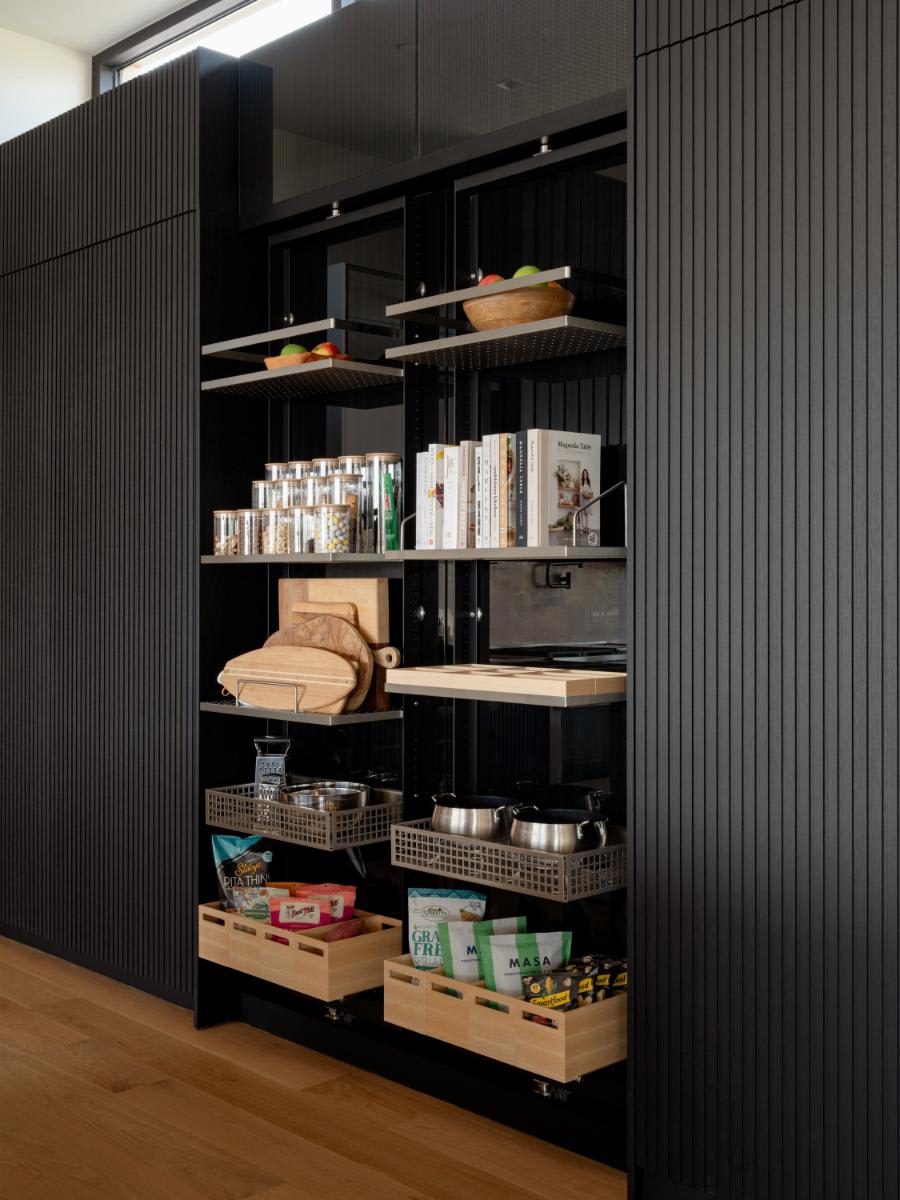 work's turnstile pantries open in a wall of lausanne wood veneer front cabinetry in a kitchen designed by eggersmann for a david lewis home