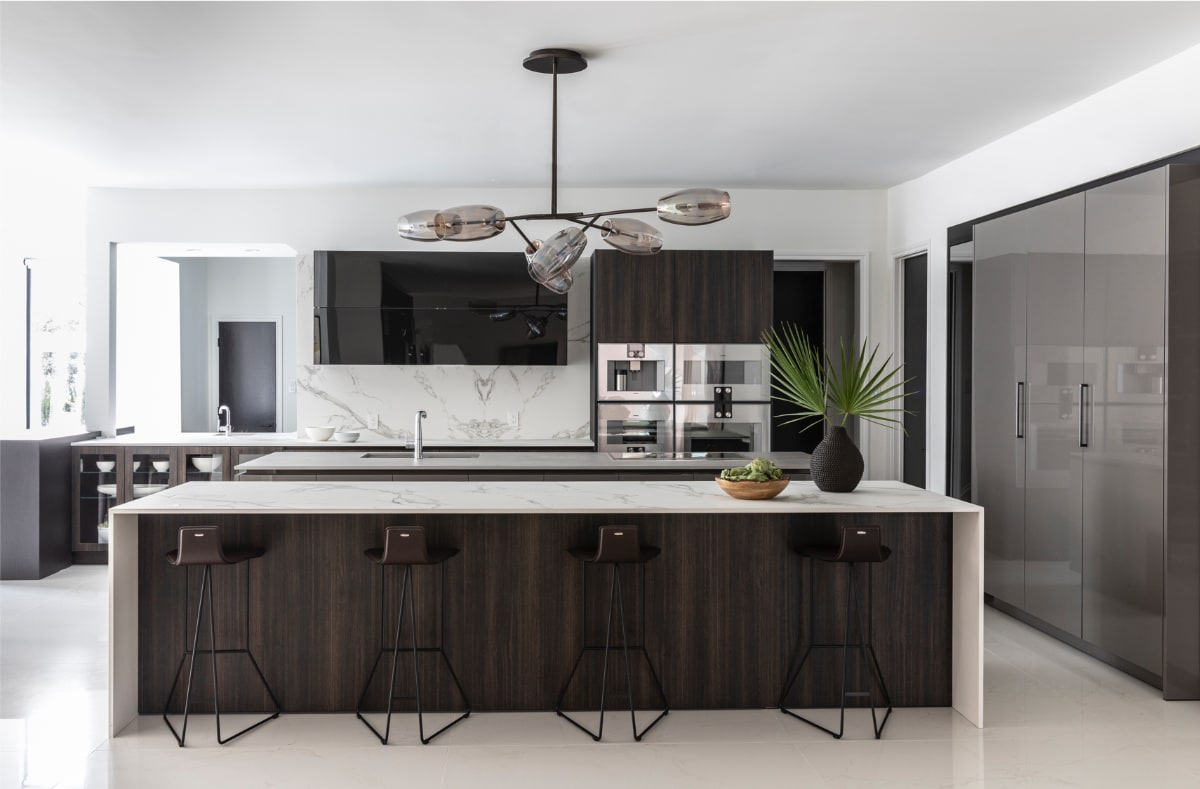eggersmann-designed kitchen with 2 islands and work's turnstile pantries in a vastu-driven Houston home renovation by nina magon