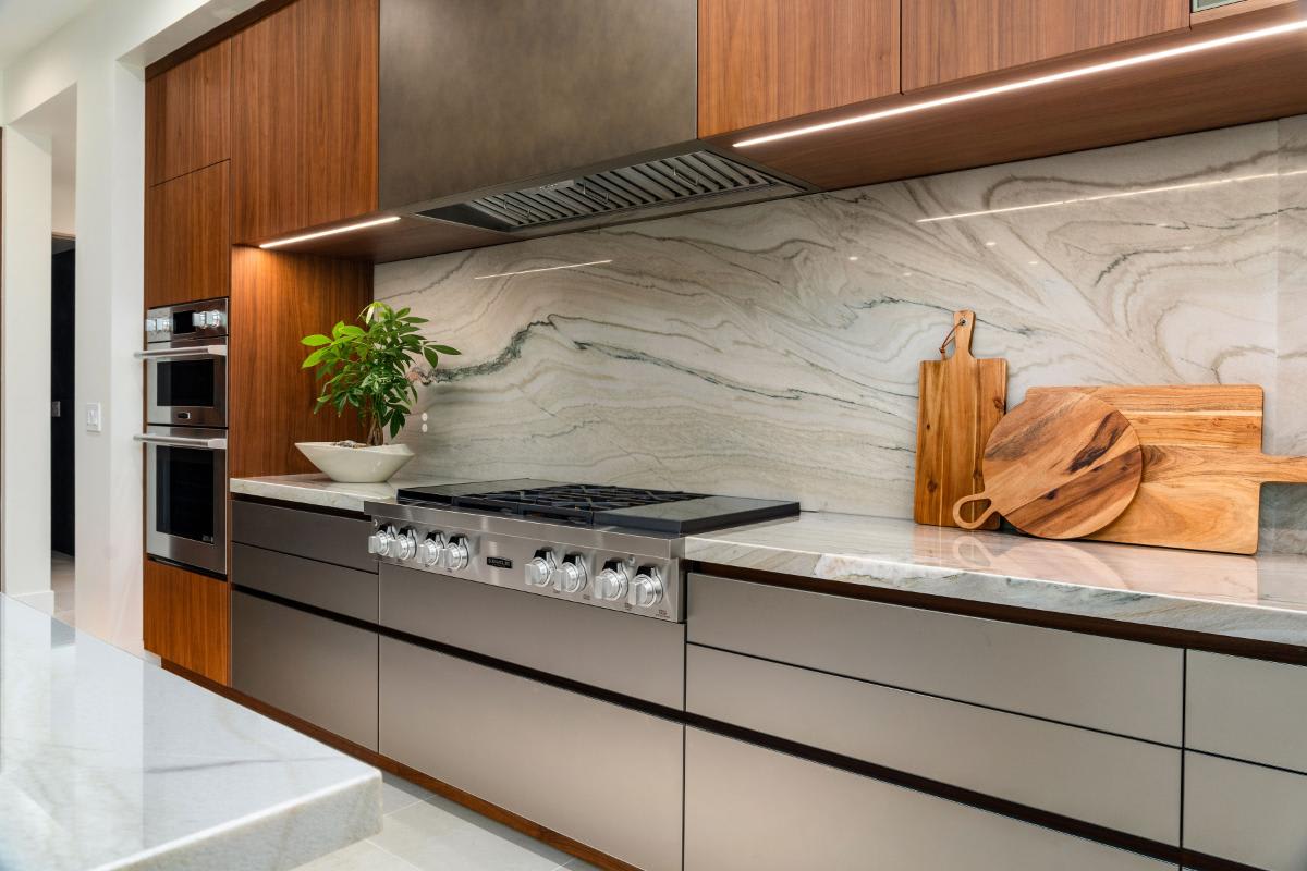 closeup of the luxury stove and custom vent hood in a modern luxury kitchen designed by eggersmann laguna for a renovated newport beach home