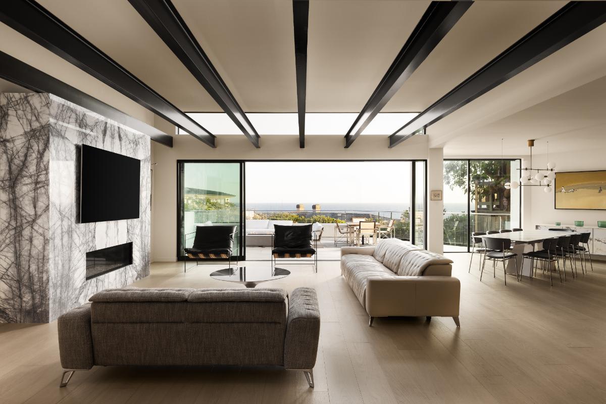 ultra modern great room with dark beamed ceilings in a lagunitas home in laguna beach