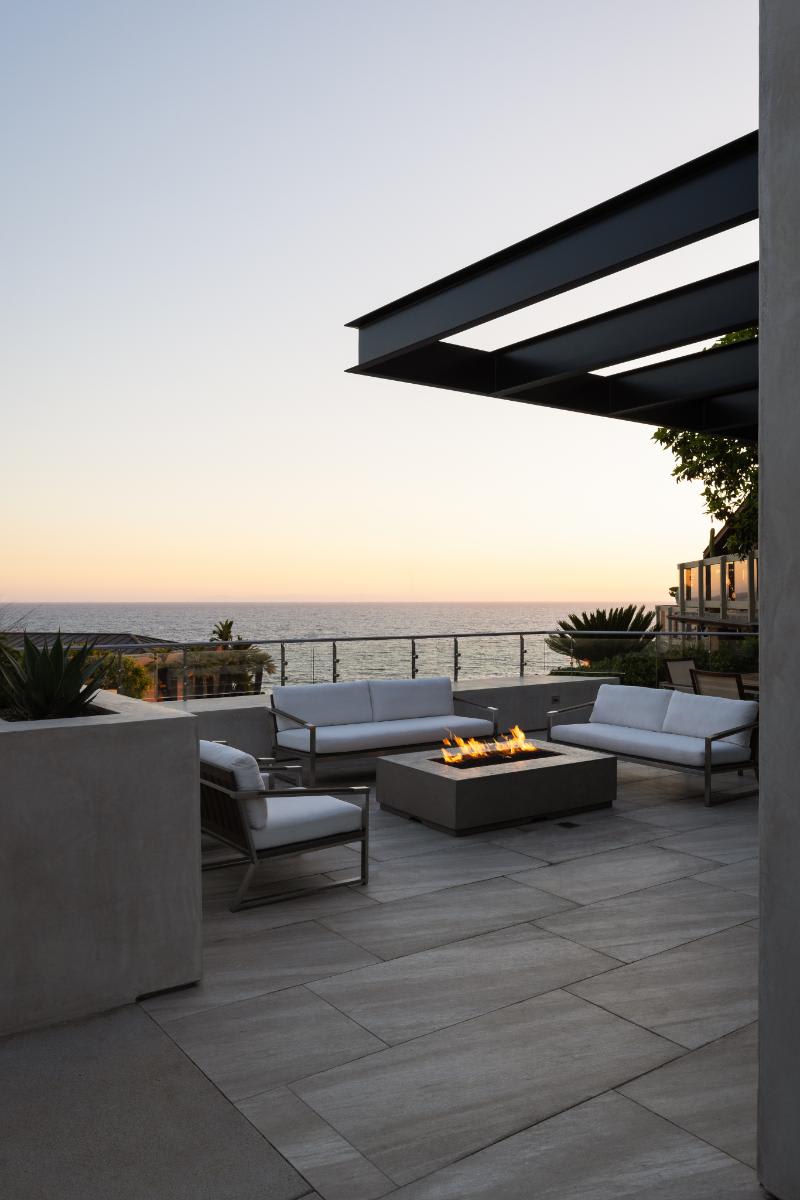 seating area with a fire pit in an exterior living space of a modern lagunitas home in laguna beach