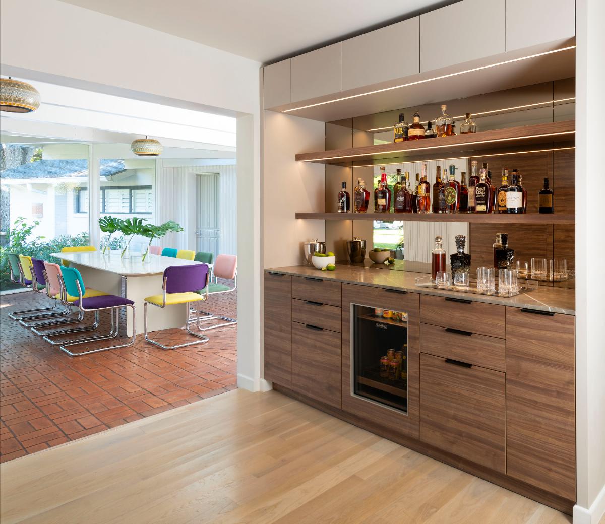 butler's bar looking into multi-colored mid-century inspired dining room designed by eggersmann for a Preston Hollow kitchen renovation