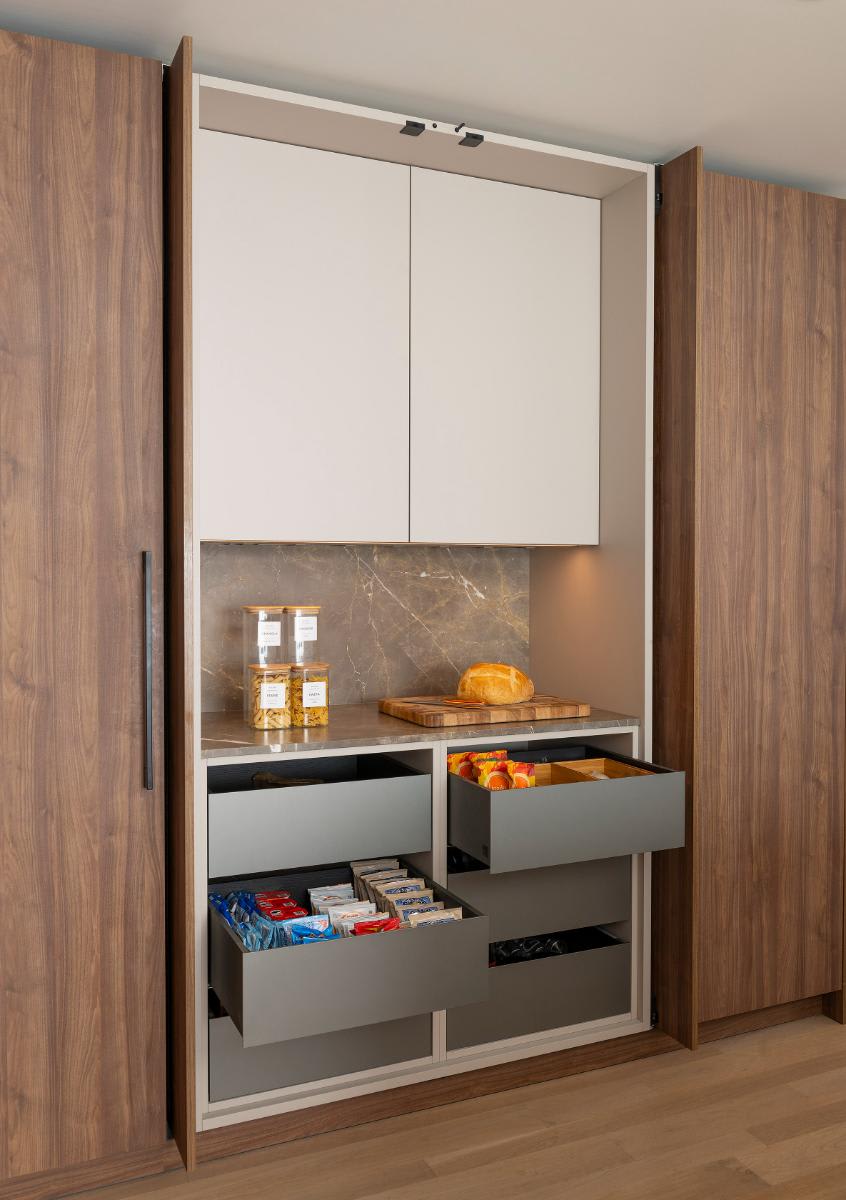 doors open to a food pantry with convenient small counter designed by eggersmann for a Preston Hollow kitchen renovation